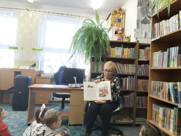 bibliotekarka-pokazuje-dzieciom-ilustracje-do-bajki-cudowna-lampa-aladyna--jpg