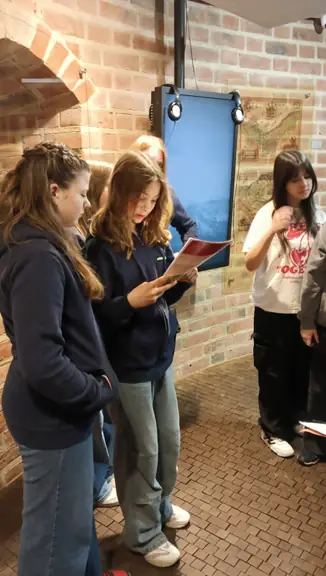 Uczniowie z Niemiec rozwiązują zadania w grze miejskiej w muzeum