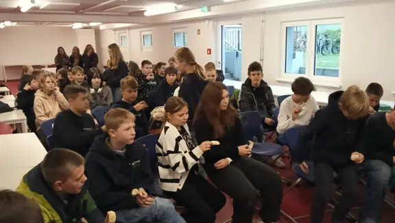 Wszyscy uczestnicy warsztatów zebrani są na dużej sali.